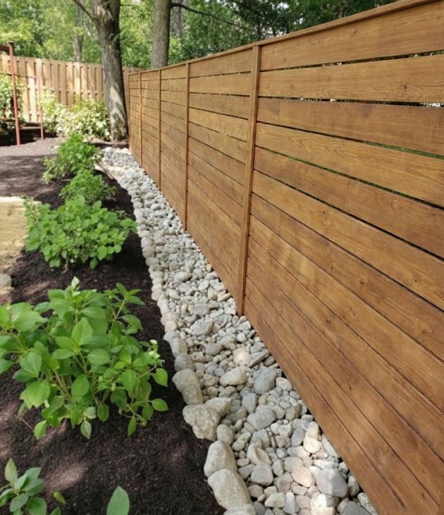 gravel French drain along a fence line in a Houston yard
