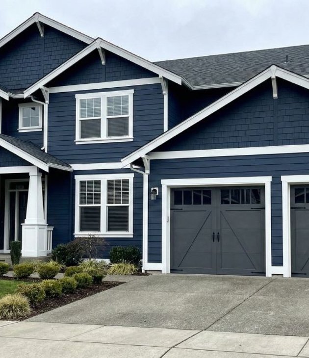 two-story home with navy lap siding and white trim
