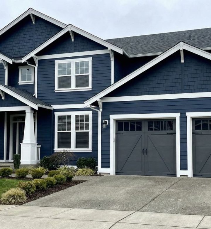 Two-story home with navy siding and white trim