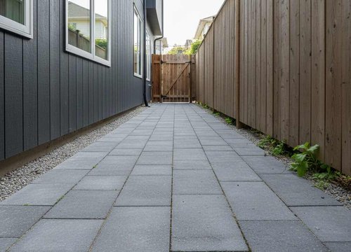 paver walkway along the side of a home