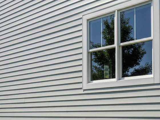 Gray lap siding and window trim on a home exterior