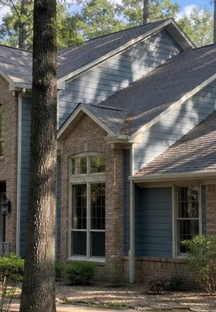 brick and blue lap siding on a two-story home